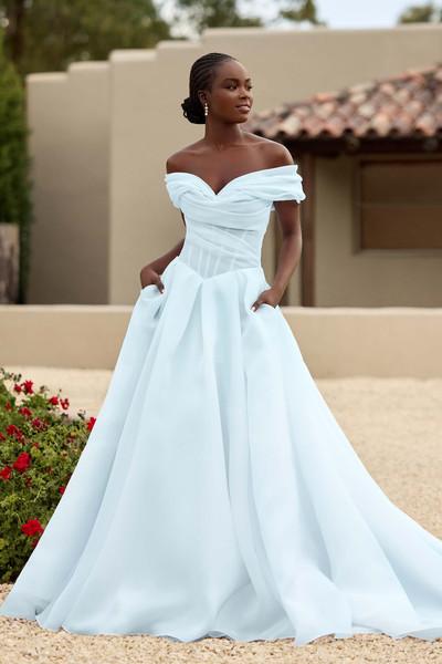 Model wearing a white gown by sophia tolli