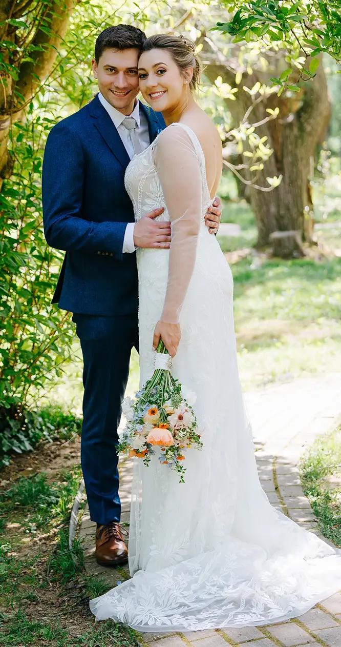 Сouple wearing a white gown and a black suit